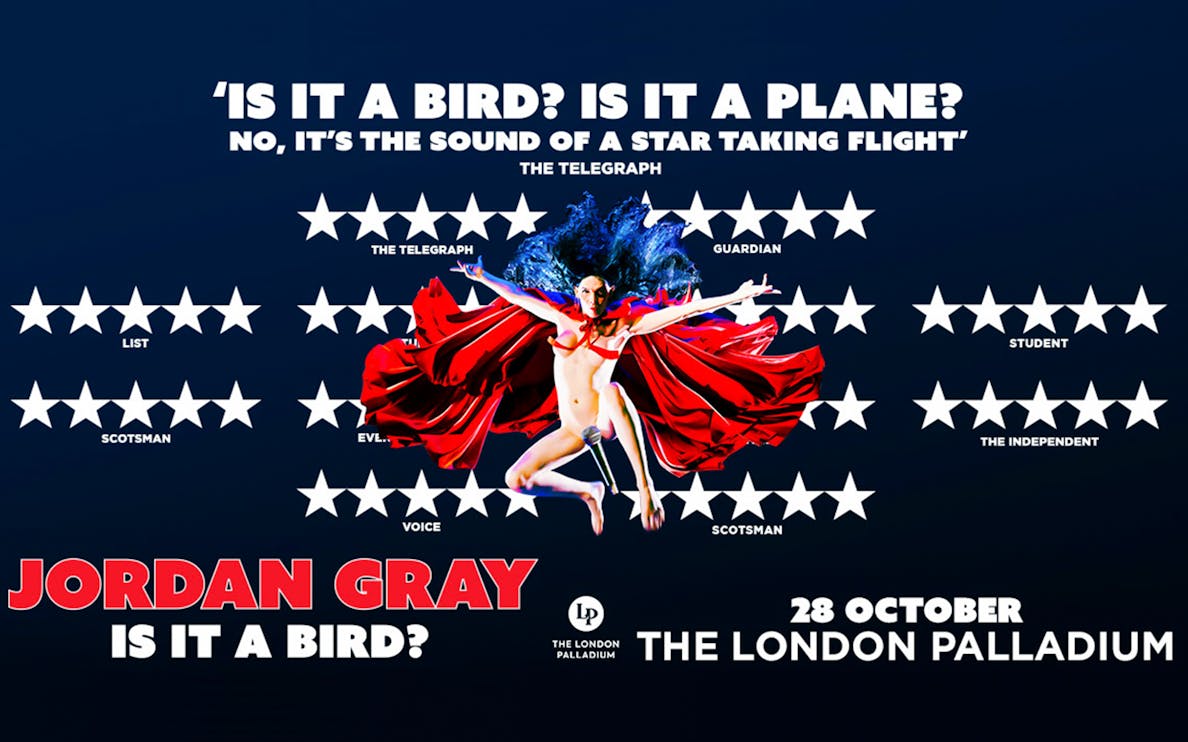 Jordan Gray performing stand-up comedy in London theater.