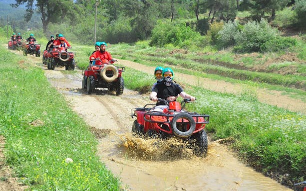 ATV riders navigating a muddy trail in Koprulu Canyon, Turkey.