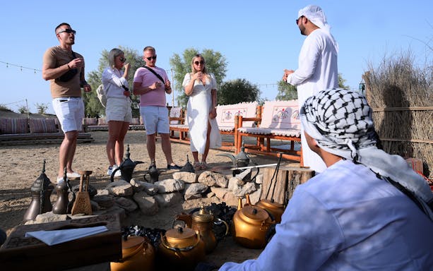 Guests enjoying traditional coffee at Al Marmoom Oasis during Morning Heritage Safari.