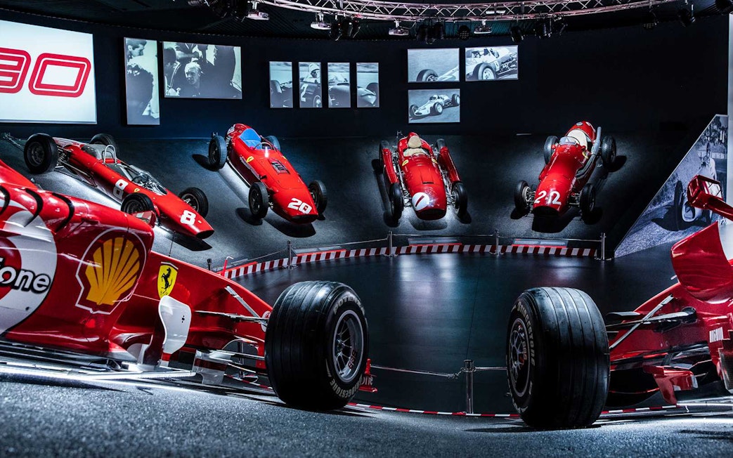 Ferrari race cars displayed at the Ferrari Museum Maranello during the Fiorano Track shuttle tour.