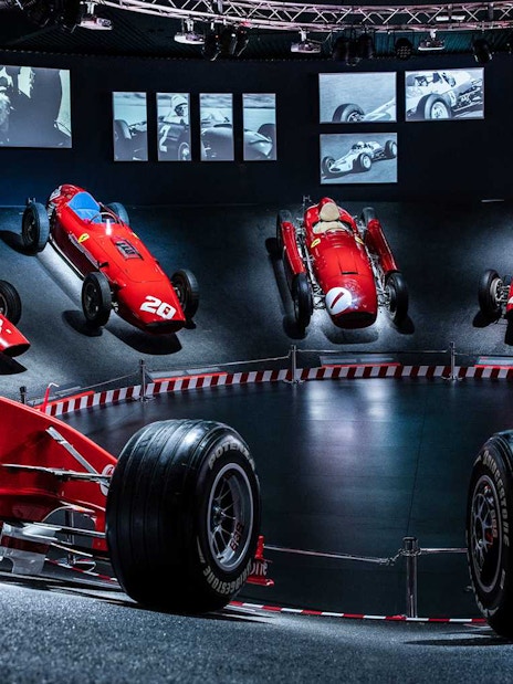 Ferrari race cars displayed at the Ferrari Museum Maranello during the Fiorano Track shuttle tour.