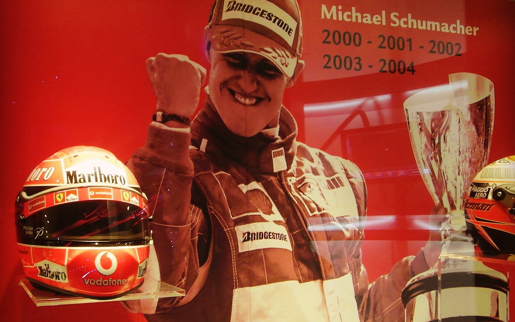 Ferrari Museum Maranello exhibit featuring racing gear and trophies.