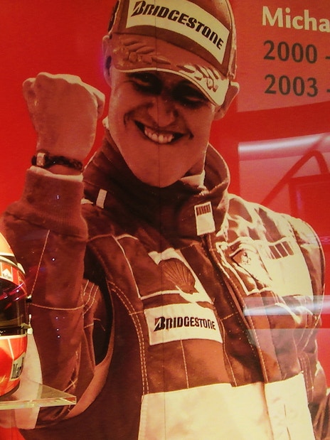 Ferrari Museum Maranello exhibit featuring racing gear and trophies.