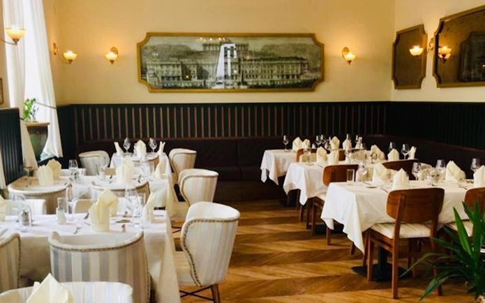 Elegant dining room set for a 3-course dinner at Schönbrunn Palace, Vienna.