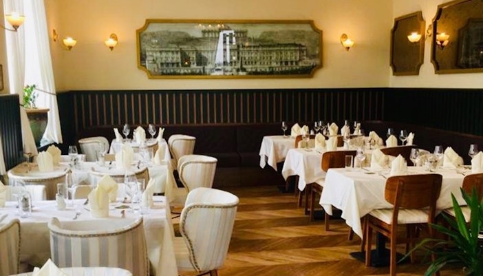 Elegant dining room set for a 3-course dinner at Schönbrunn Palace, Vienna.