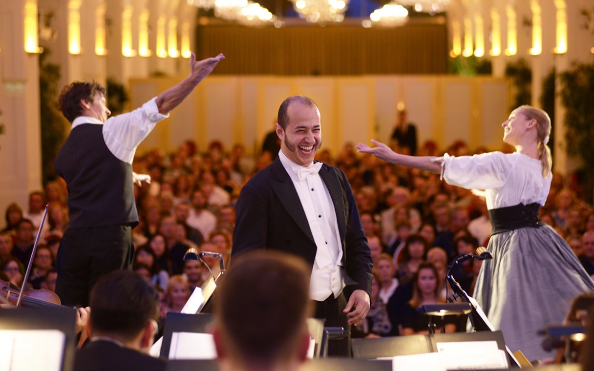 Mozart and Strauss concert performance at Schönbrunn Palace with musicians and audience.
