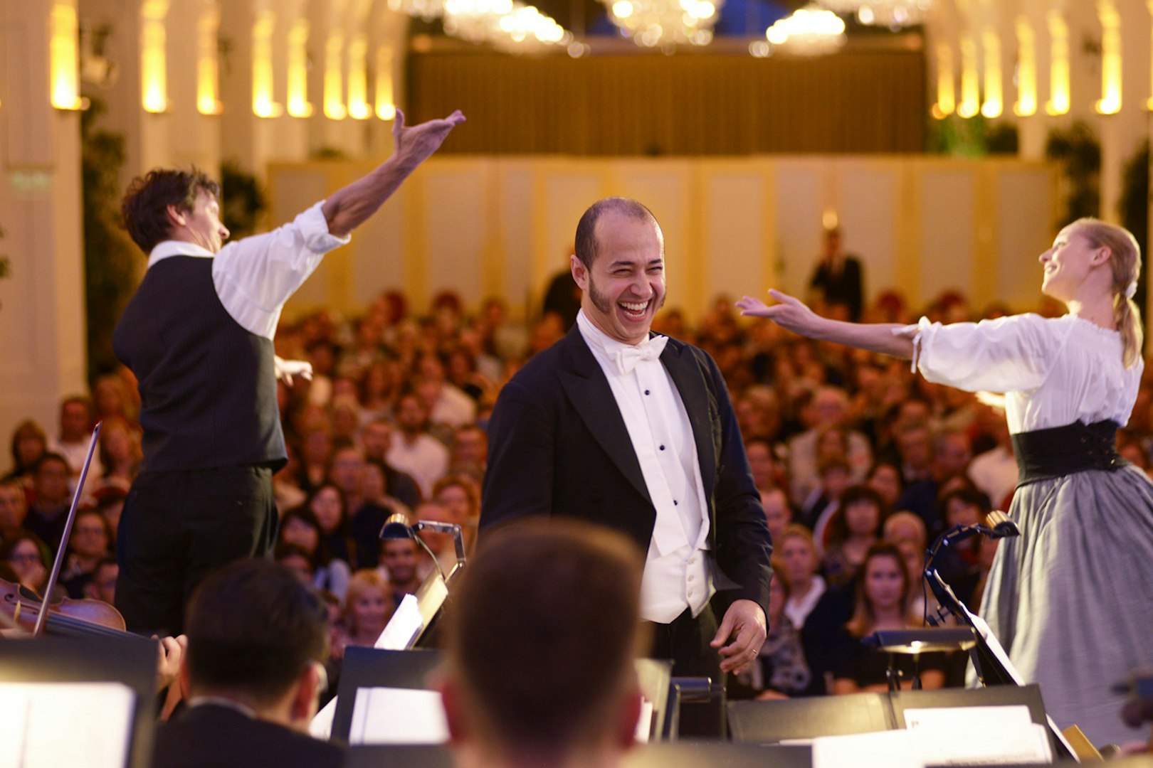 Mozart and Strauss concert performance at Schönbrunn Palace with musicians and audience.