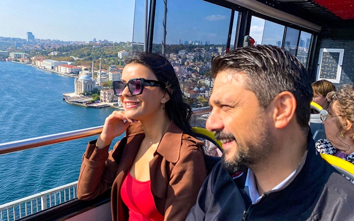 Tourists enjoying views of Istanbul from a hop-on hop-off bus near the Bosphorus.