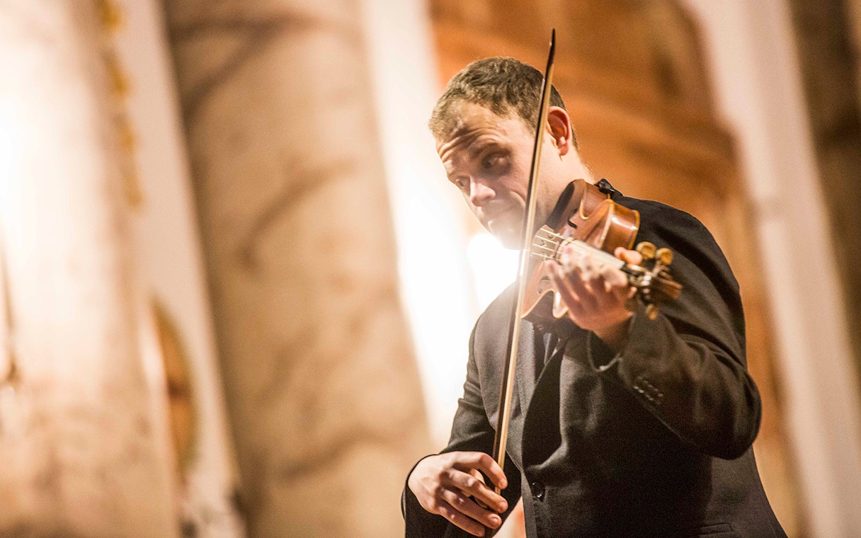 Violinist performing at Vivaldi’s Four Seasons concert in Karlskirche, Vienna.