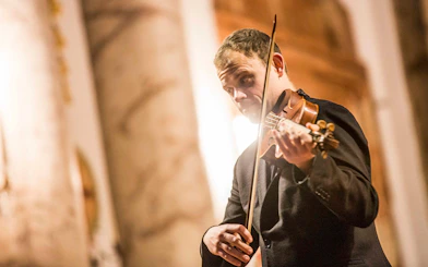 Violinist performing at Vivaldi’s Four Seasons concert in Karlskirche, Vienna.