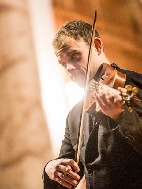 Violinist performing at Vivaldi’s Four Seasons concert in Karlskirche, Vienna.