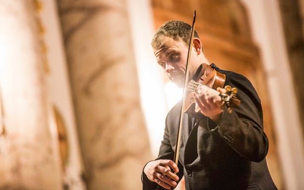 Violinist performing at Vivaldi’s Four Seasons concert in Karlskirche, Vienna.