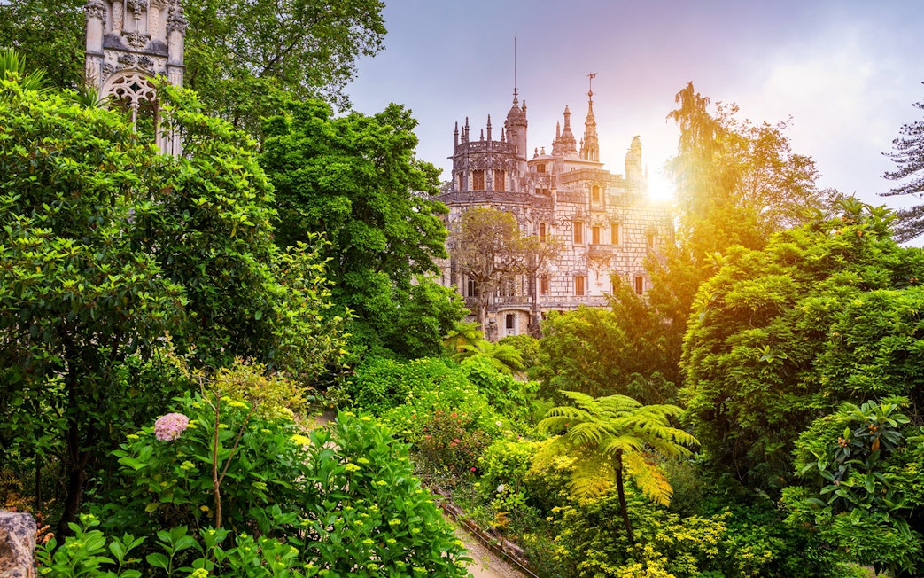 Quinta da Regaleira surrounded by lush gardens in Sintra, Portugal.
