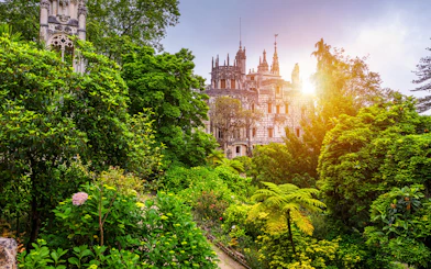 Quinta da Regaleira surrounded by lush gardens in Sintra, Portugal.
