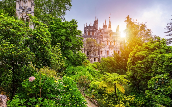Quinta da Regaleira surrounded by lush gardens in Sintra, Portugal.