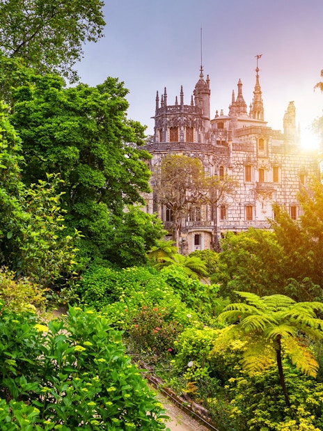 Quinta da Regaleira surrounded by lush gardens in Sintra, Portugal.