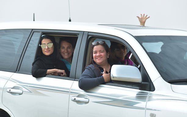 Group enjoying Doha Half-Day Desert Safari in a 4x4 vehicle.