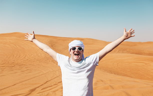 Man enjoying Doha desert landscape during half-day safari.