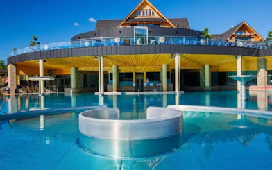 Chocholow Thermal Baths Saunarium with outdoor pool and modern architecture.