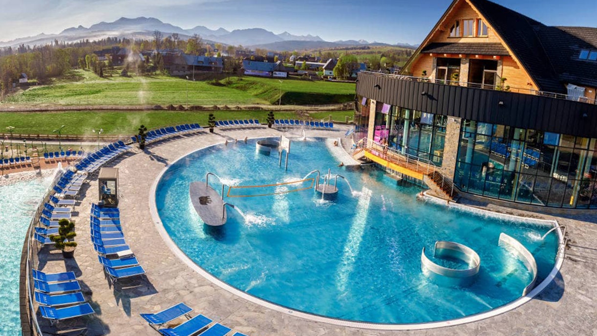 Outdoor pool at Chocholow Thermal Baths with mountain view in Poland.
