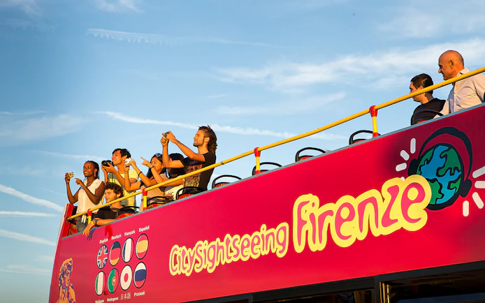 Tourists on an open-top bus during a Florence sightseeing tour.
