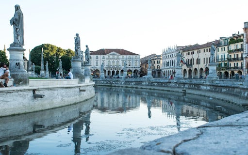 Prato della Valle with statues and canal in Padua, Italy, on a sightseeing bus tour.