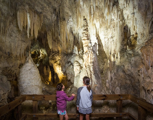 Visitors exploring stalactites and stalagmites in Aranui Cave during a guided tour.