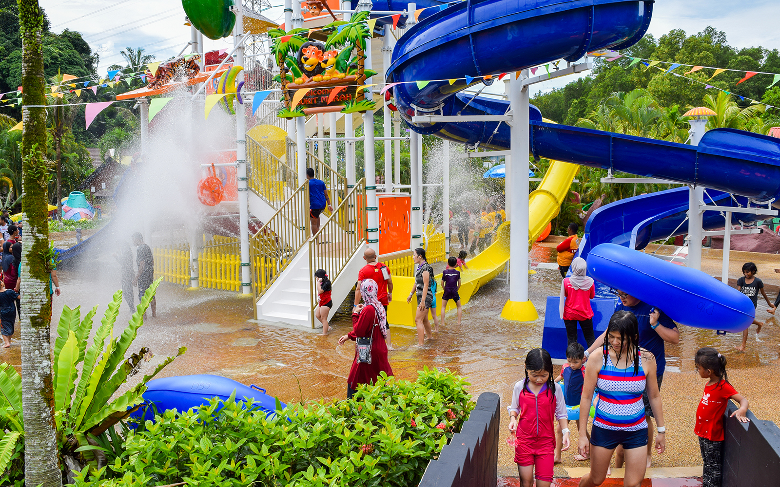Visitors enjoying water slides at Bukit Merah Laketown Waterpark, Malaysia.