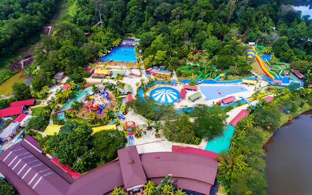 Aerial view of Bukit Merah Laketown Waterpark with pools, slides, and surrounding greenery.