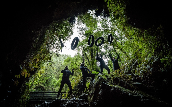 Adventurers in wetsuits prepare for black water rafting in Waitomo cave.