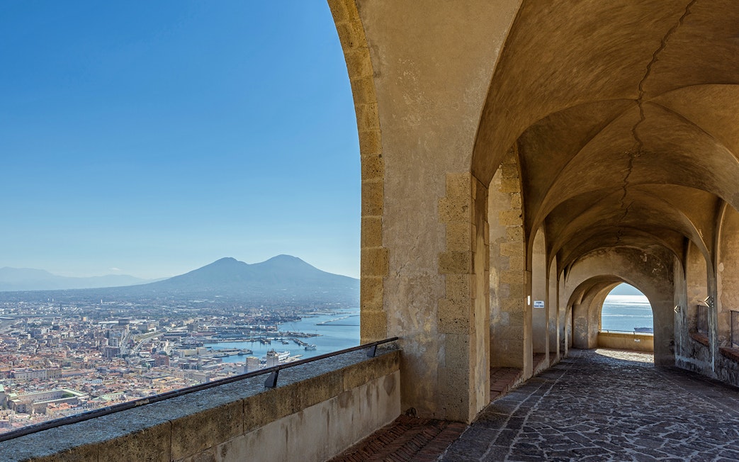 Arched walkway at Castel Sant'Elmo overlooking Naples and Mount Vesuvius.