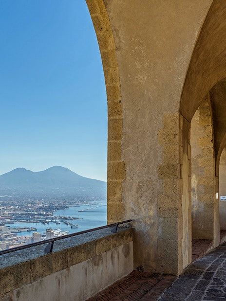 Arched walkway at Castel Sant'Elmo overlooking Naples and Mount Vesuvius.