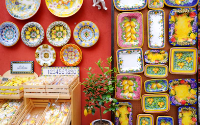 Colorful ceramic plates and lemon-themed pottery on display in Sorrento shop.
