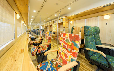 Colorful train interior with patterned seats on the Southern Kyushu Area Pass route.