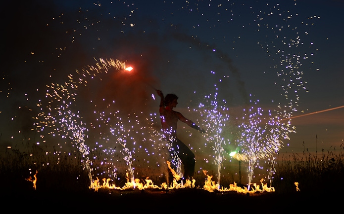 Performer at Uluwatu Kecak & Fire Dance Show with fire and sparks.