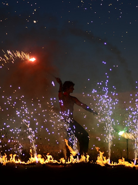 Performer at Uluwatu Kecak & Fire Dance Show with fire and sparks.
