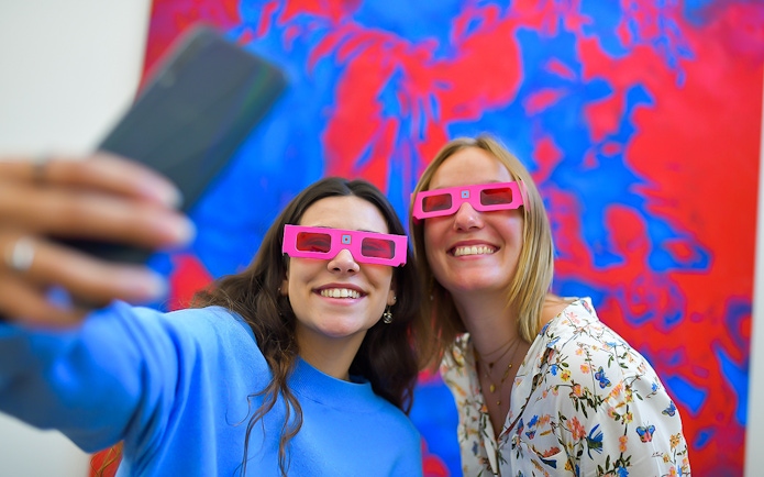 Visitors wearing 3D glasses at Illusion Art Museum Prague.