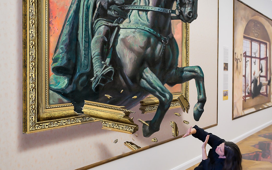 Horse sculpture illusion at Illusion Art Museum Prague with visitor interacting.