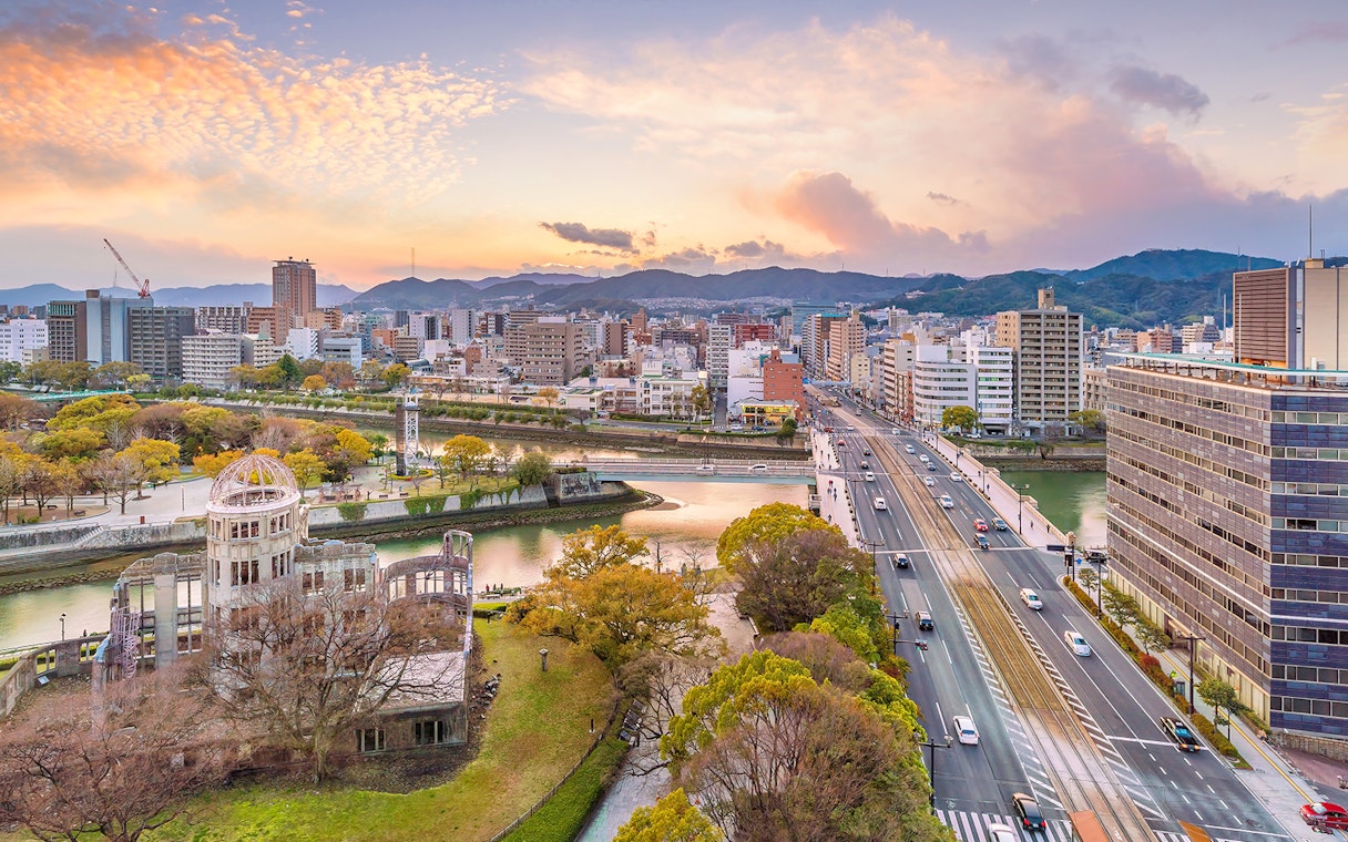 Hiroshima cityscape with Atomic Bomb Dome and Motoyasu River at sunset.