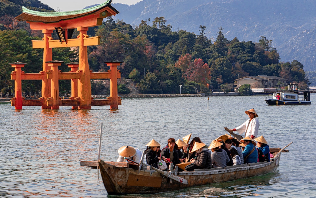 Boat tour near Itsukushima Shrine's torii gate, Hiroshima, Japan.