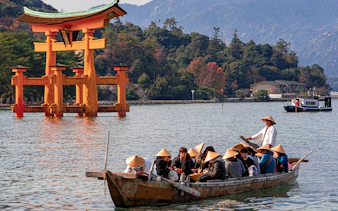 Boat tour near Itsukushima Shrine's torii gate, Hiroshima, Japan.