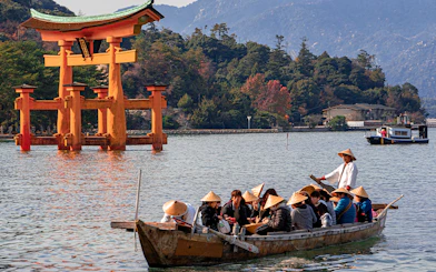 Boat tour near Itsukushima Shrine's torii gate, Hiroshima, Japan.