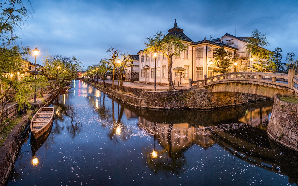 Canal with traditional buildings and bridge in Kurashiki, Japan, part of 7 Day JR Setouchi Area Pass.