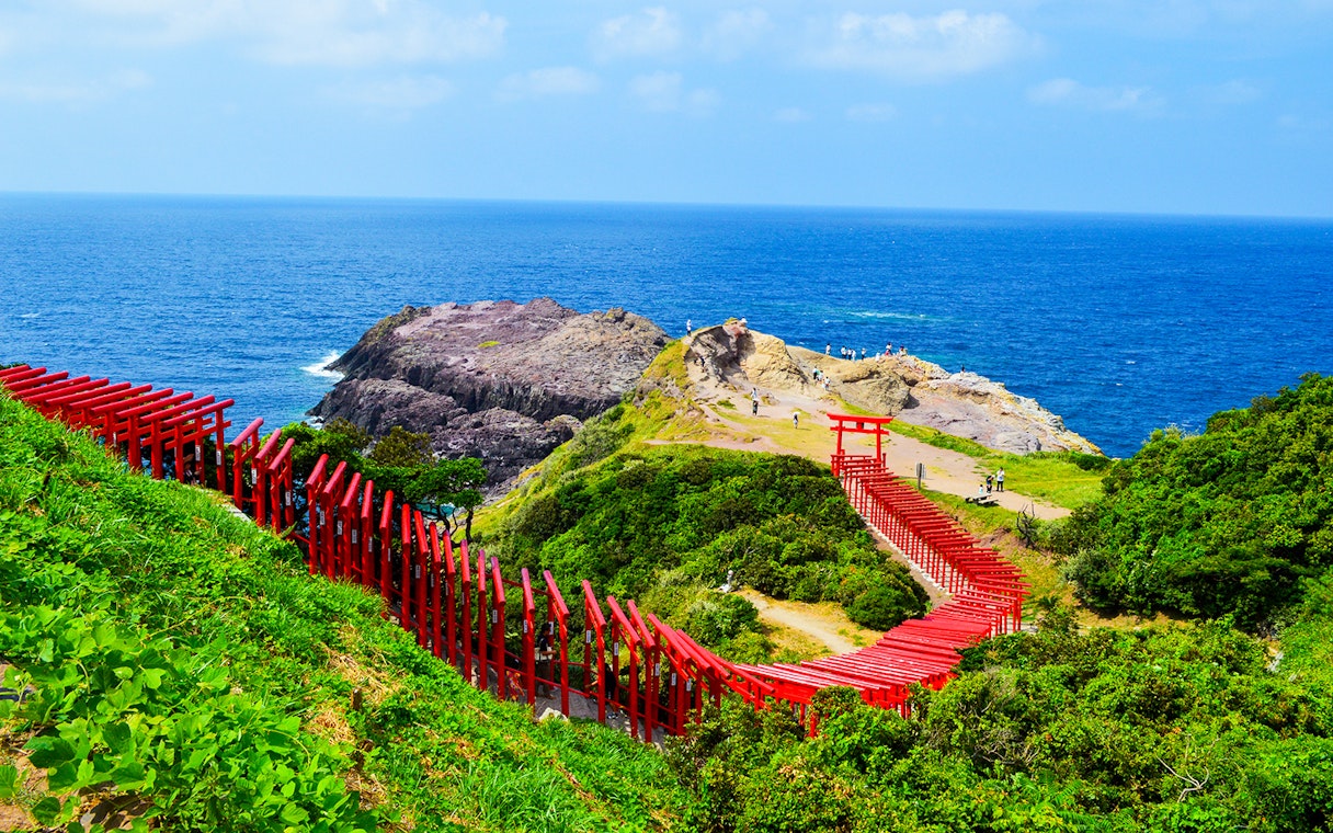 Red torii gates leading to Motonosumi Shrine overlooking the Sea of Japan, Setouchi Area.