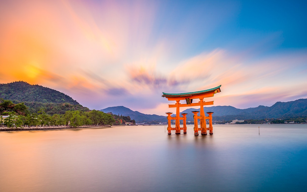 Torii gate at Itsukushima Shrine, Miyajima Island, Japan, during sunset.