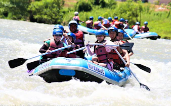 White water rafting group navigating rapids in Sabah.