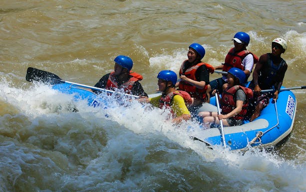 White water rafting group navigating rapids in Sabah.