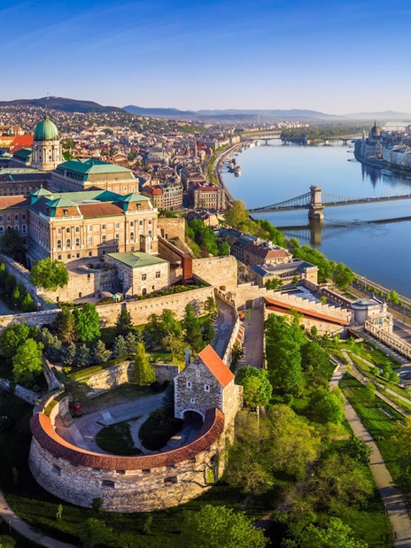 Aerial view of Buda Castle and Chain Bridge along the Danube River in Budapest.