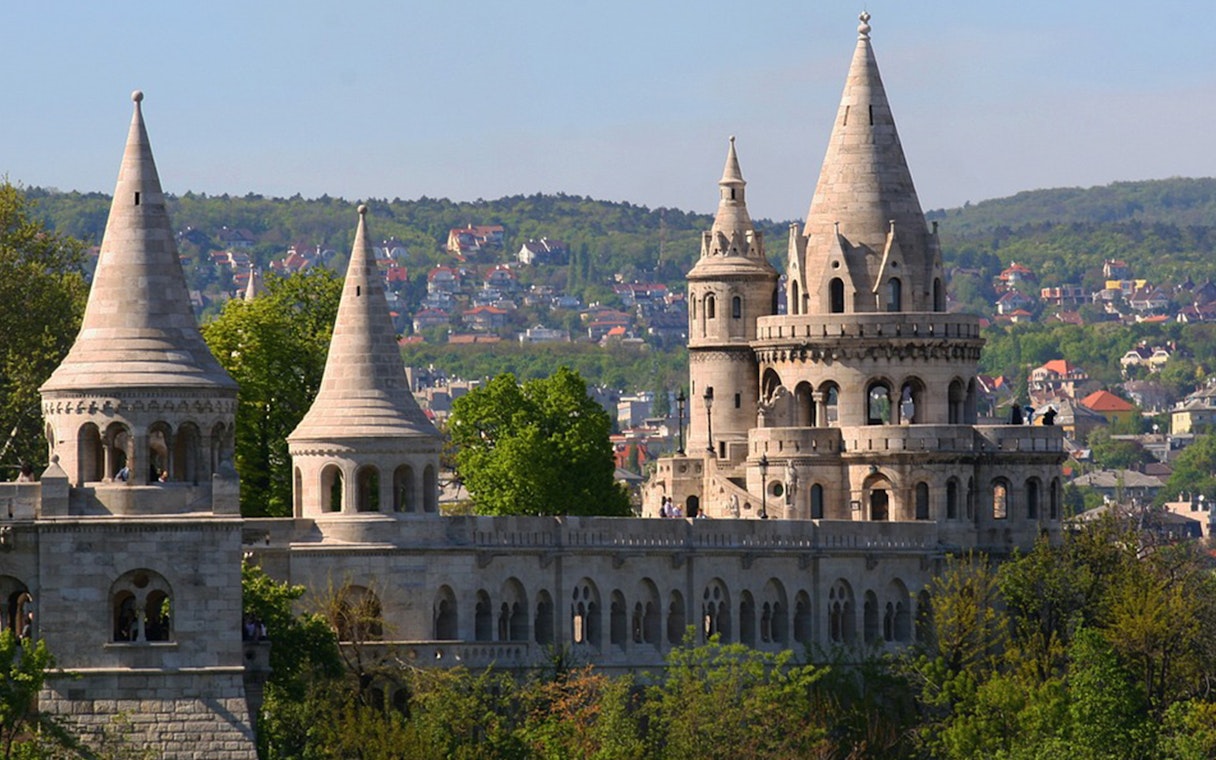Fisherman's Bastion towers in Budapest with cityscape in the background.