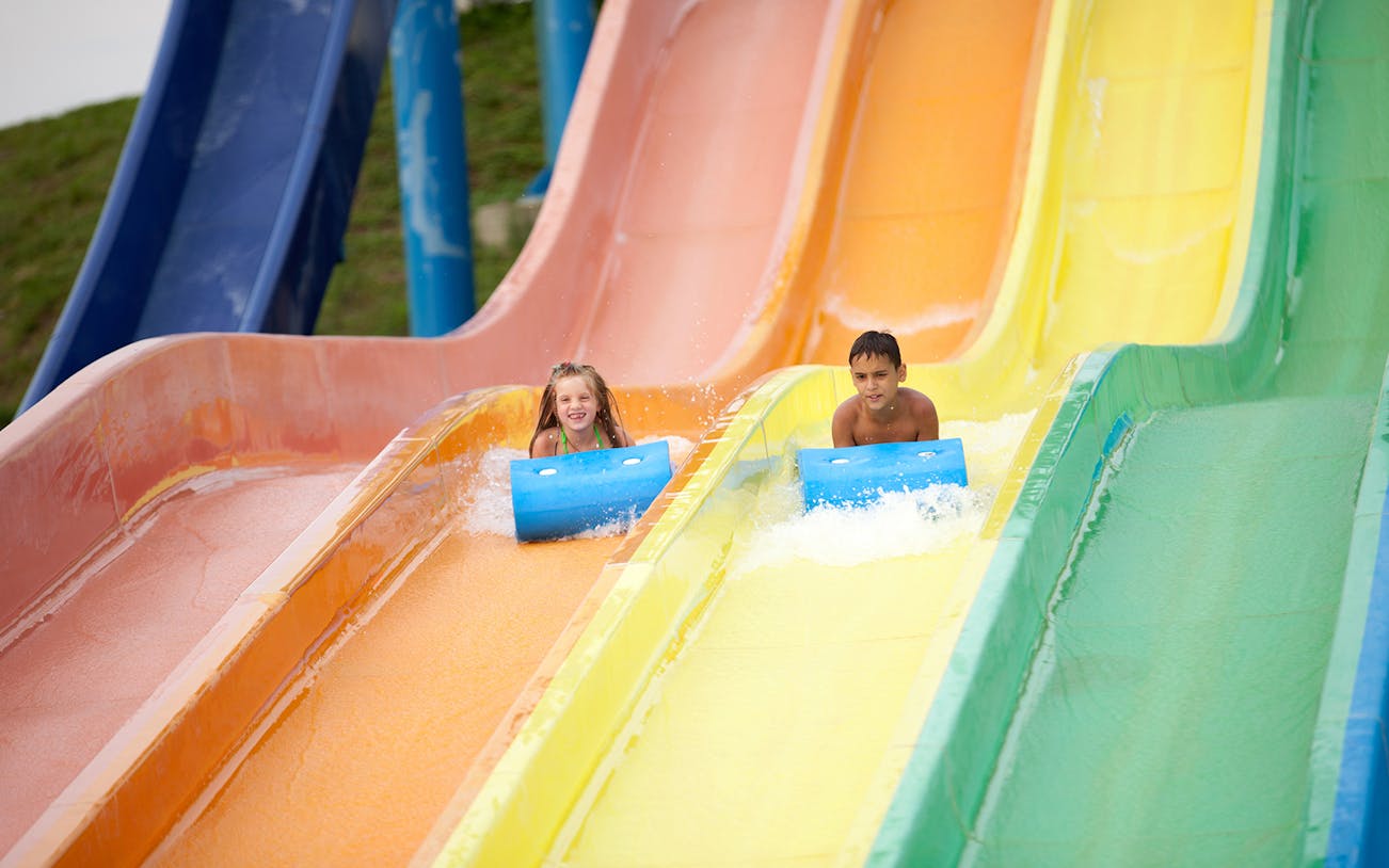Children enjoying colorful water slides at Ehsan Waterpark.